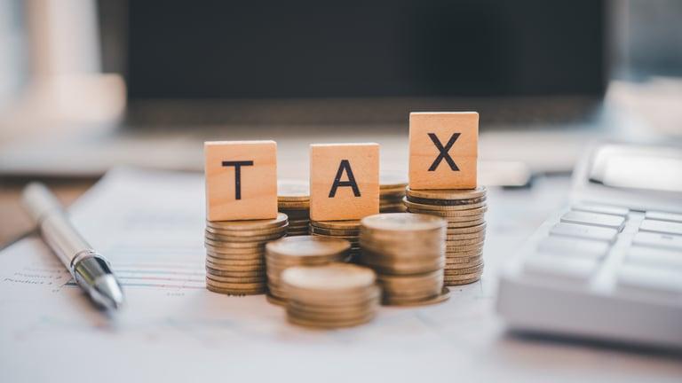 Business owner setting aside money for their upcoming tax bill after summer