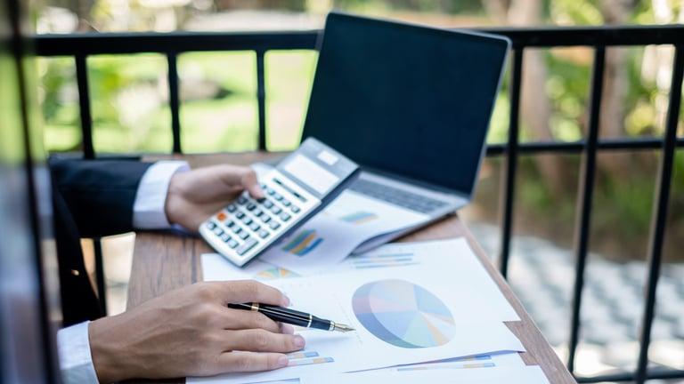 Trusted colleague managing essential bookkeeping tasks while the business owner is away