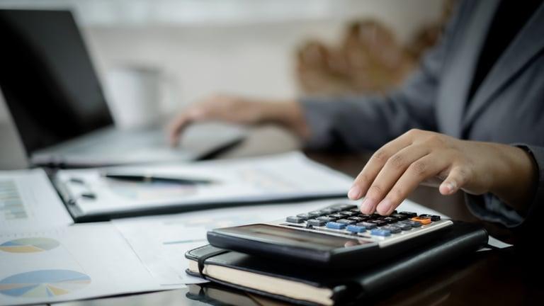 Small business owner tidying up bookkeeping before the Christmas break